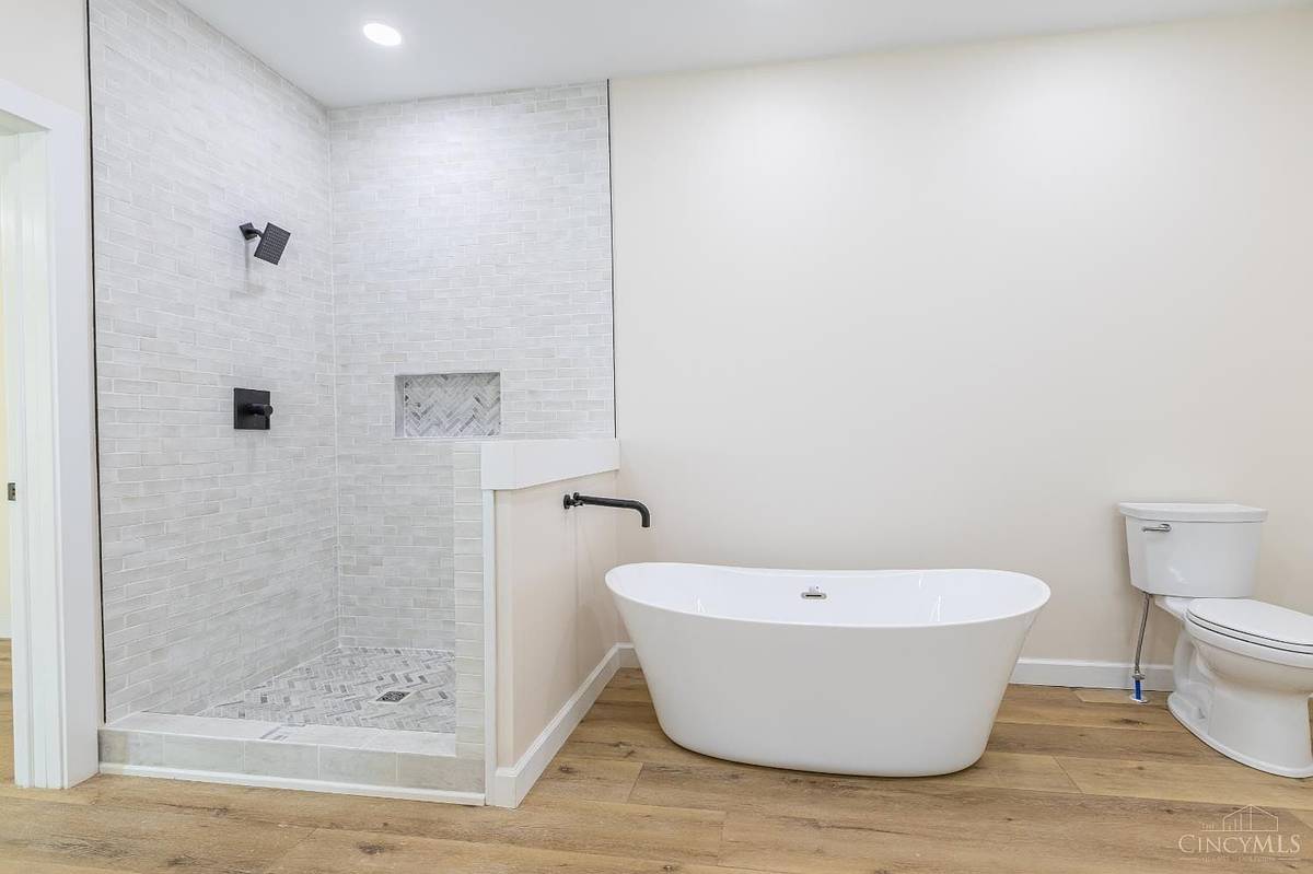 Primary bath with freestanding tub and tiled shower