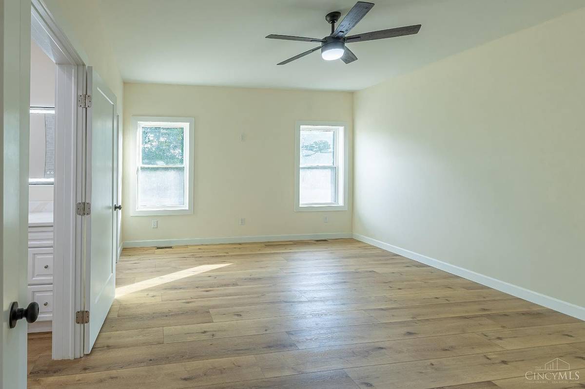 Bedroom with ceiling fan and natural light