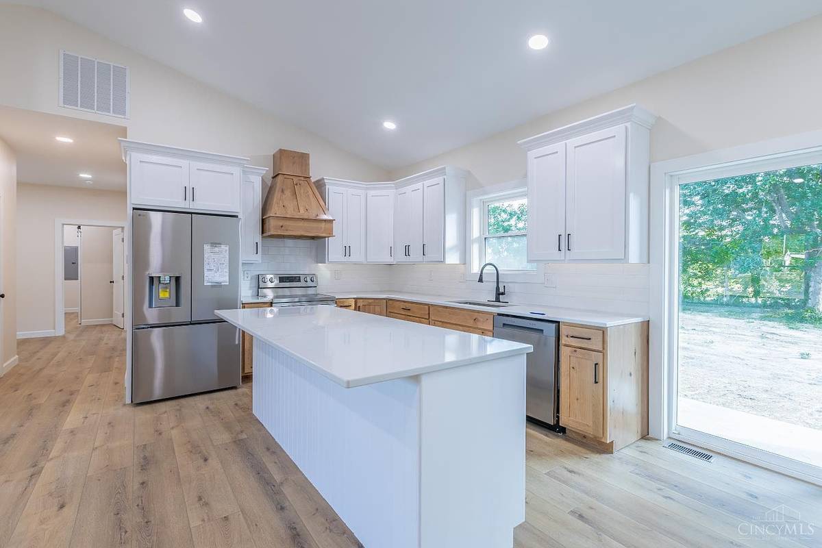 Custom kitchen with quartz island and knotty alder cabinetry