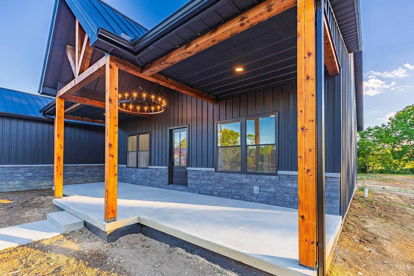 Timber-post front porch with chandelier
